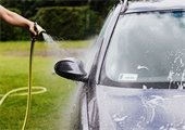 Car being washed on grass