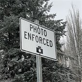 Sign on pole that reads Photo Enforced