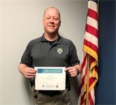 Detective Craig Teschlog holding a certificate