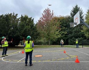 NEMCo volunteers practicing with a drone