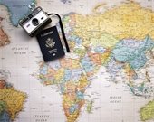 passport and camera on world map