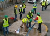 Volunteers hooking up a hose to a fire hydrant