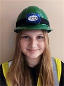 Teen member of CERT wearing green hardhat and yellow vest
