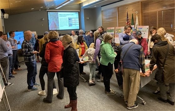 People standing and engaging with each other and staff at the Lake Front Park Property Workshop