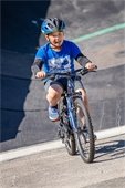 Child riding a bike while wearing a bike helmet
