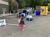 People in parking lot with dunk tank in background